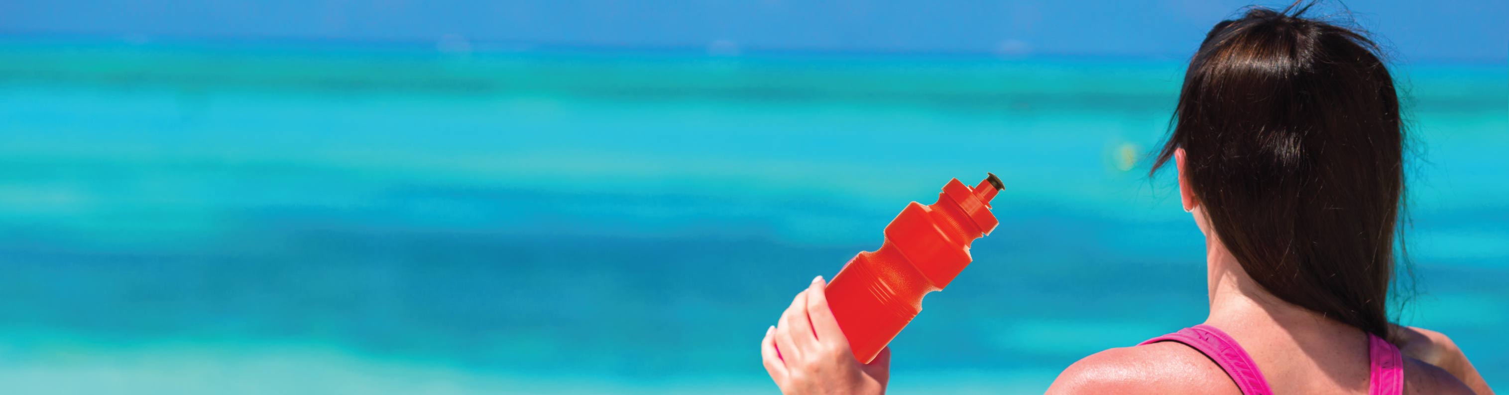 Using a sports water bottle at the beach